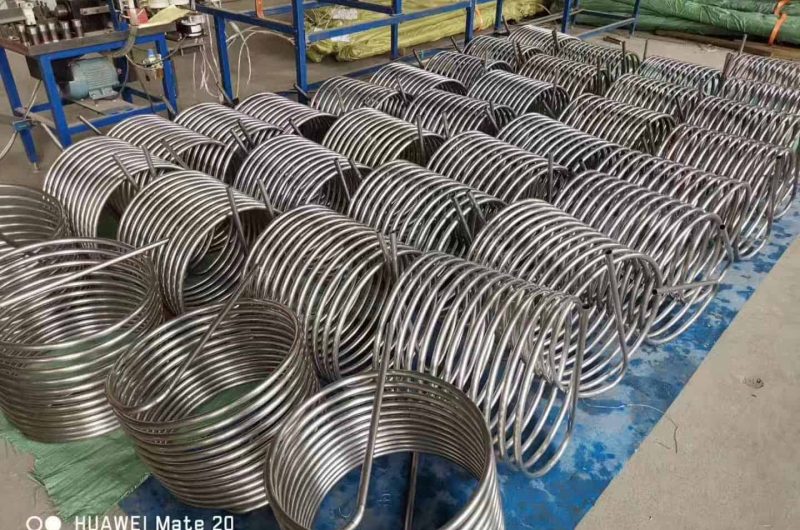 helical coil tubing for fluid extraction