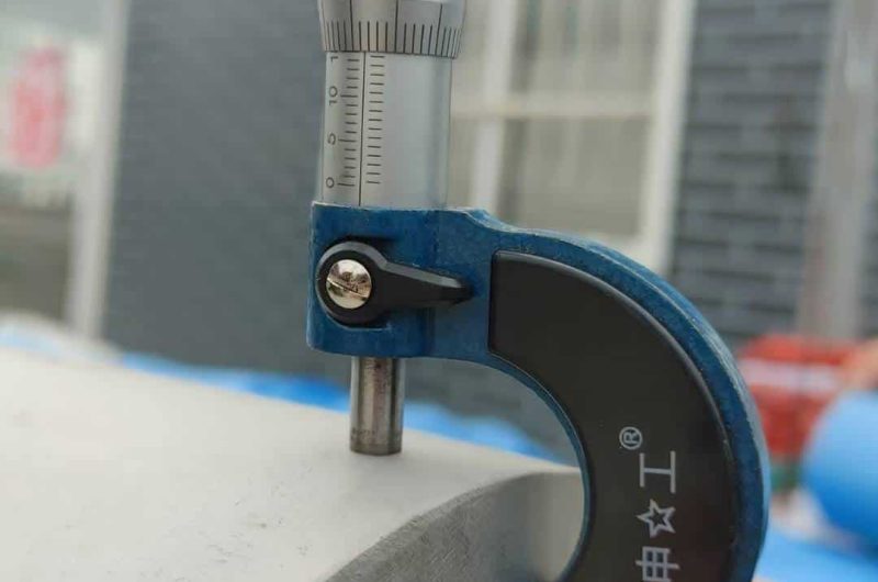 handheld ultrasonic thickness gauge on stainless pipe wall