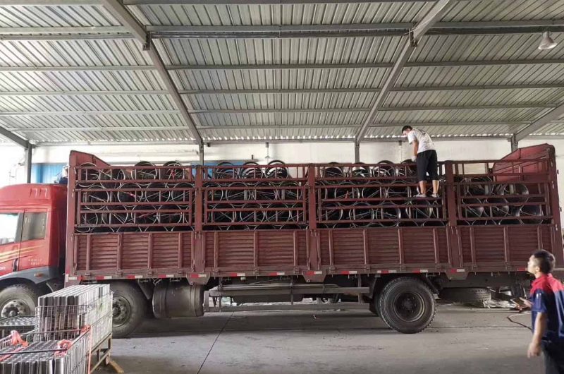 warehouse worker loading steel pipes