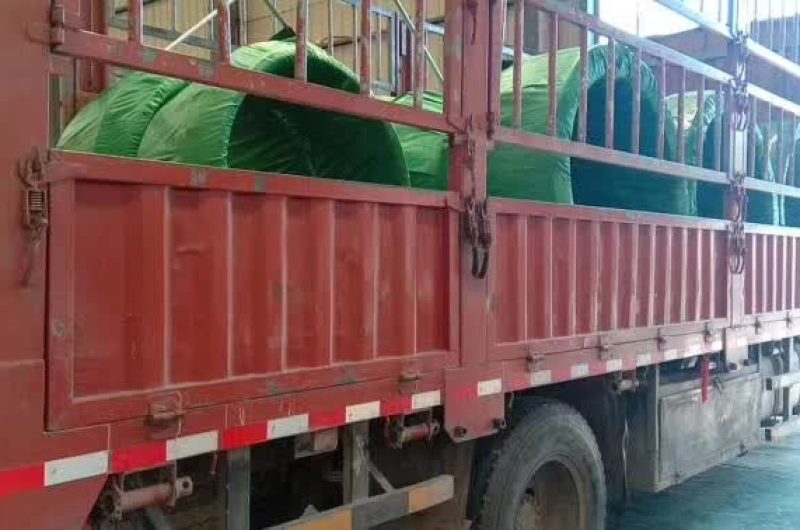 loading stainless tube into open-top container