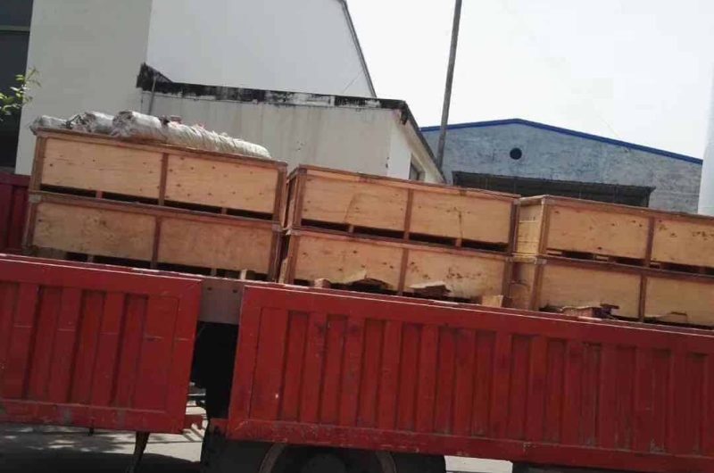 pipes being loaded onto flatbed truck