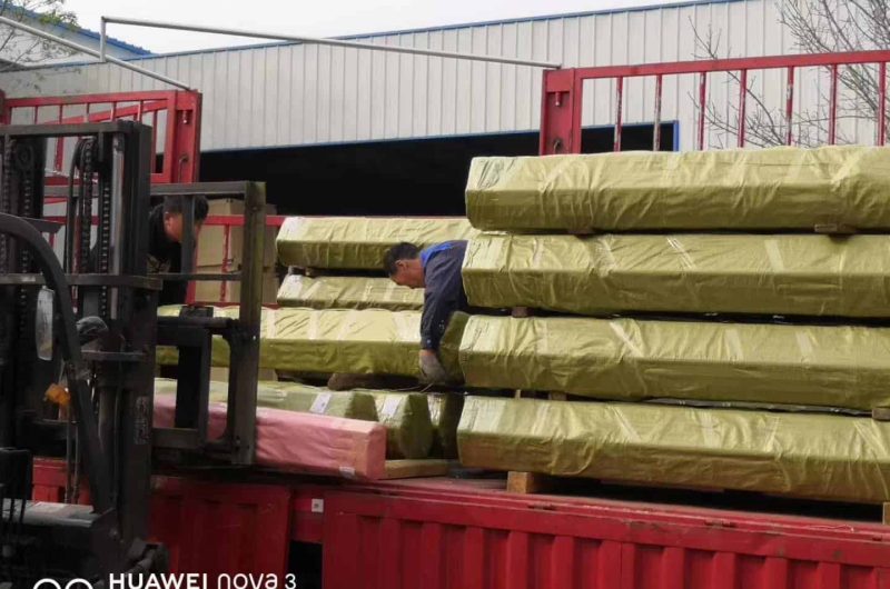 forklift loading stainless steel pipe into export container