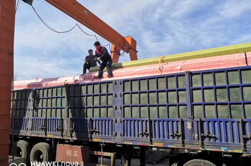 heavy-duty truck transporting stainless steel pipes